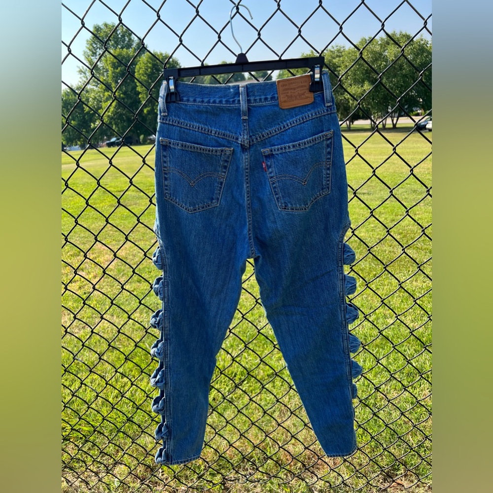 Levi jeans with bow detailing down each leg in size 26.